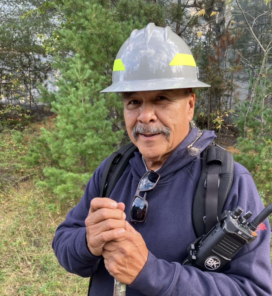 Vern Northrup uses long experience to supervise protection of certain trees.